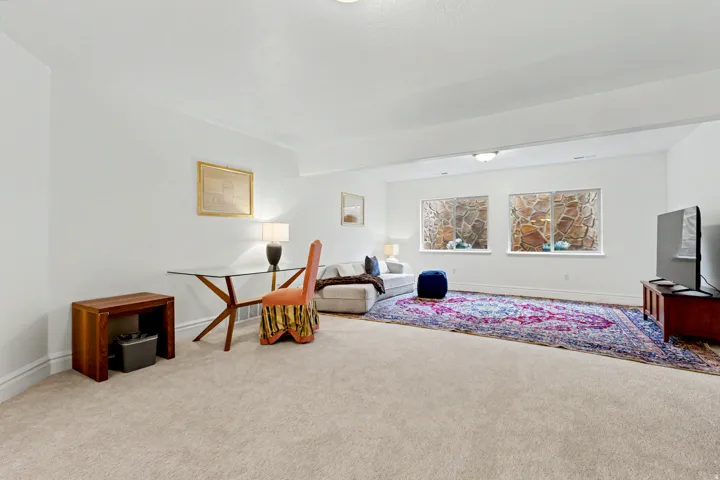 Sitting room with carpet floors and baseboards