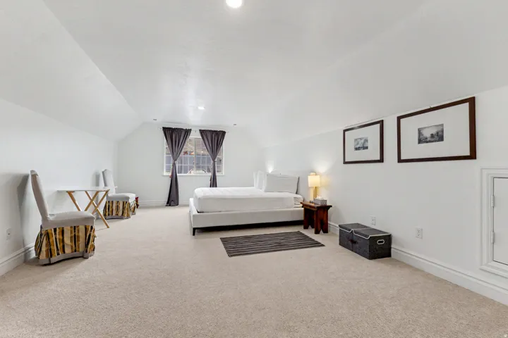 Bedroom with light carpet and recessed lighting