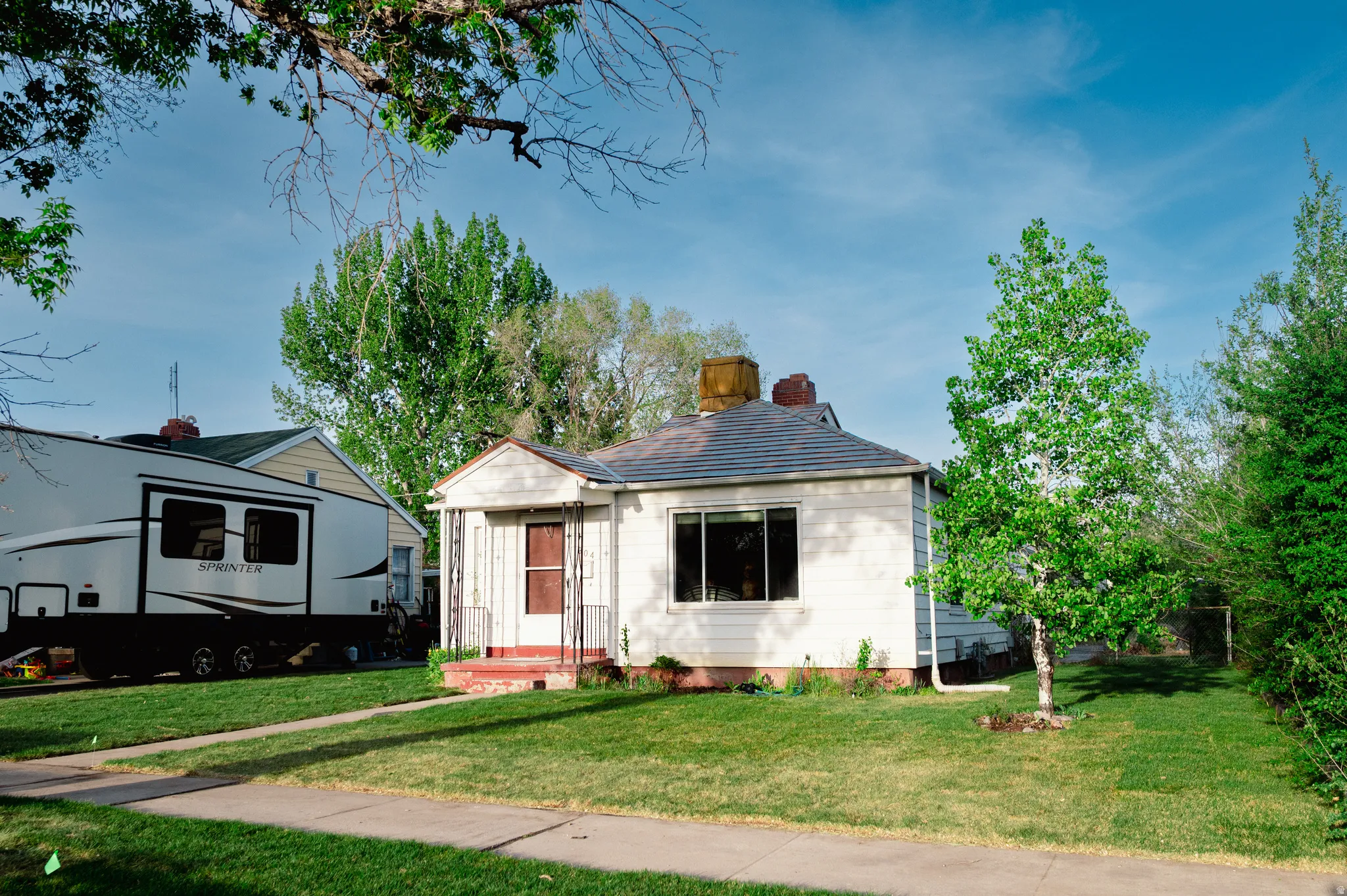 Bungalow with a chimney and a front yard