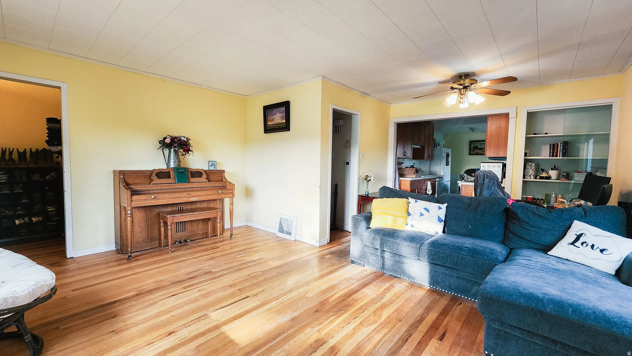Living area featuring light wood-type flooring and ceiling fan