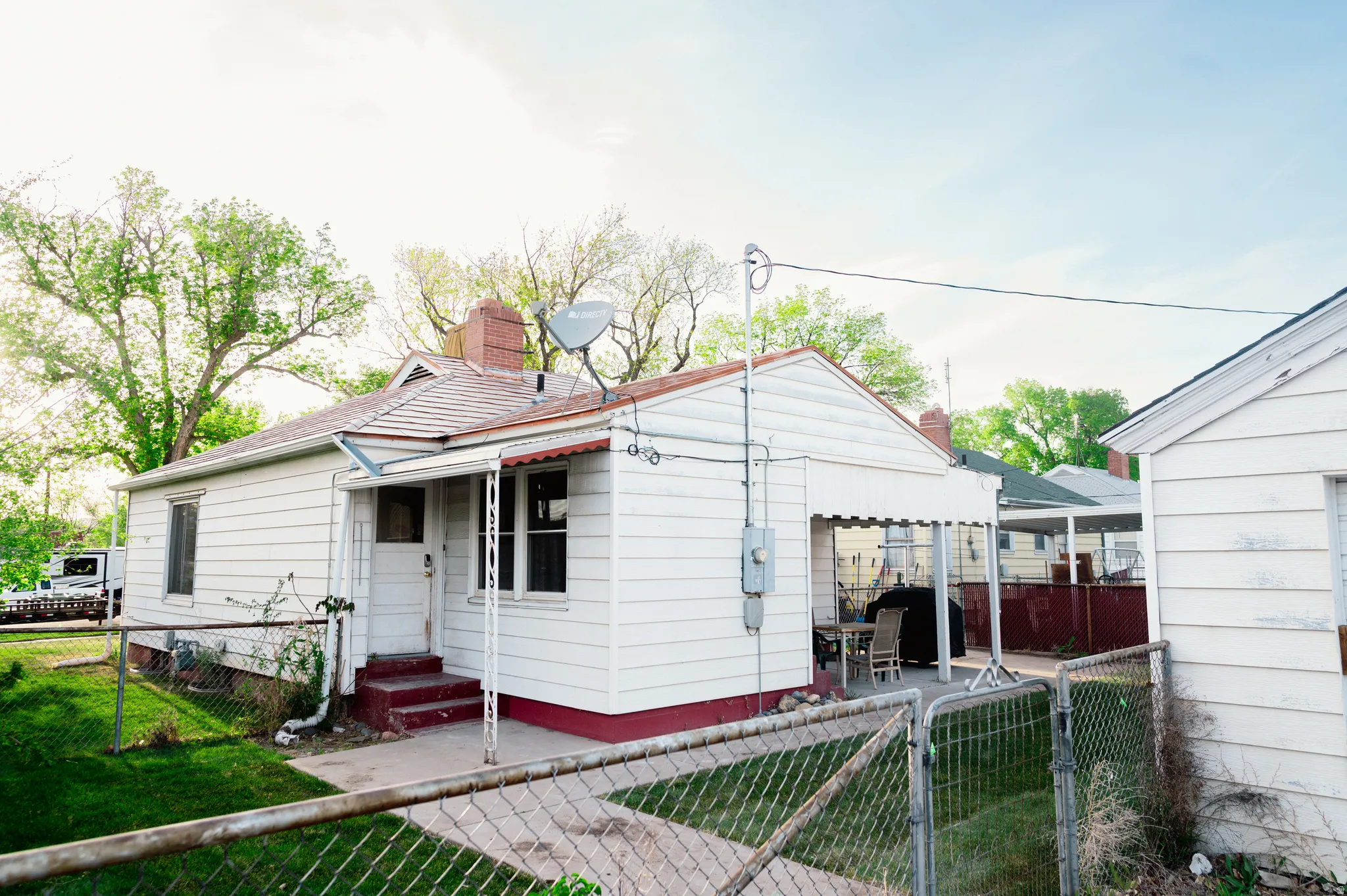 Back of property featuring a gate, a fenced front yard, and a chimney