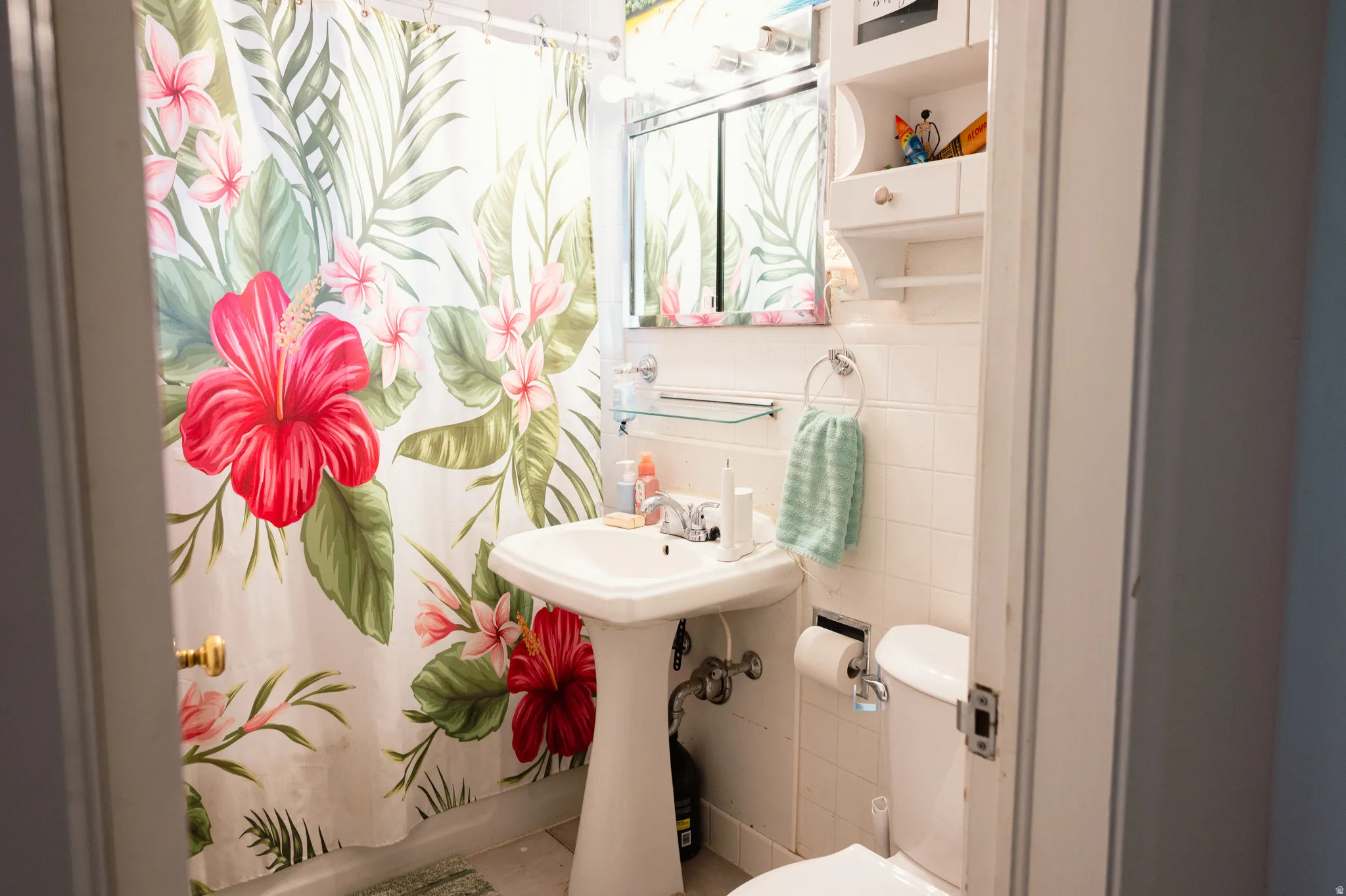 Bathroom with toilet and tile walls