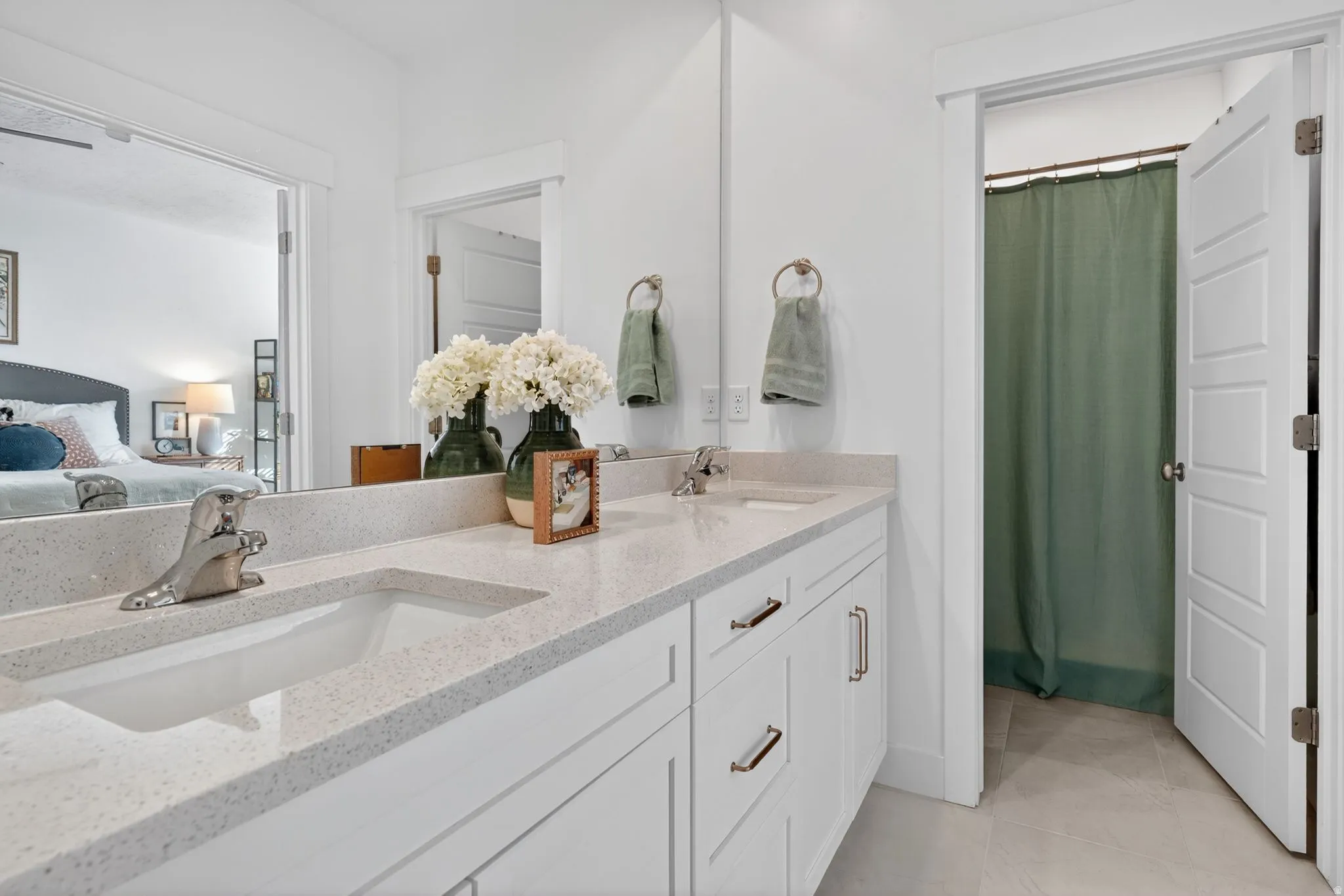 Full bathroom with double vanity, ensuite bathroom, and a shower with shower curtain