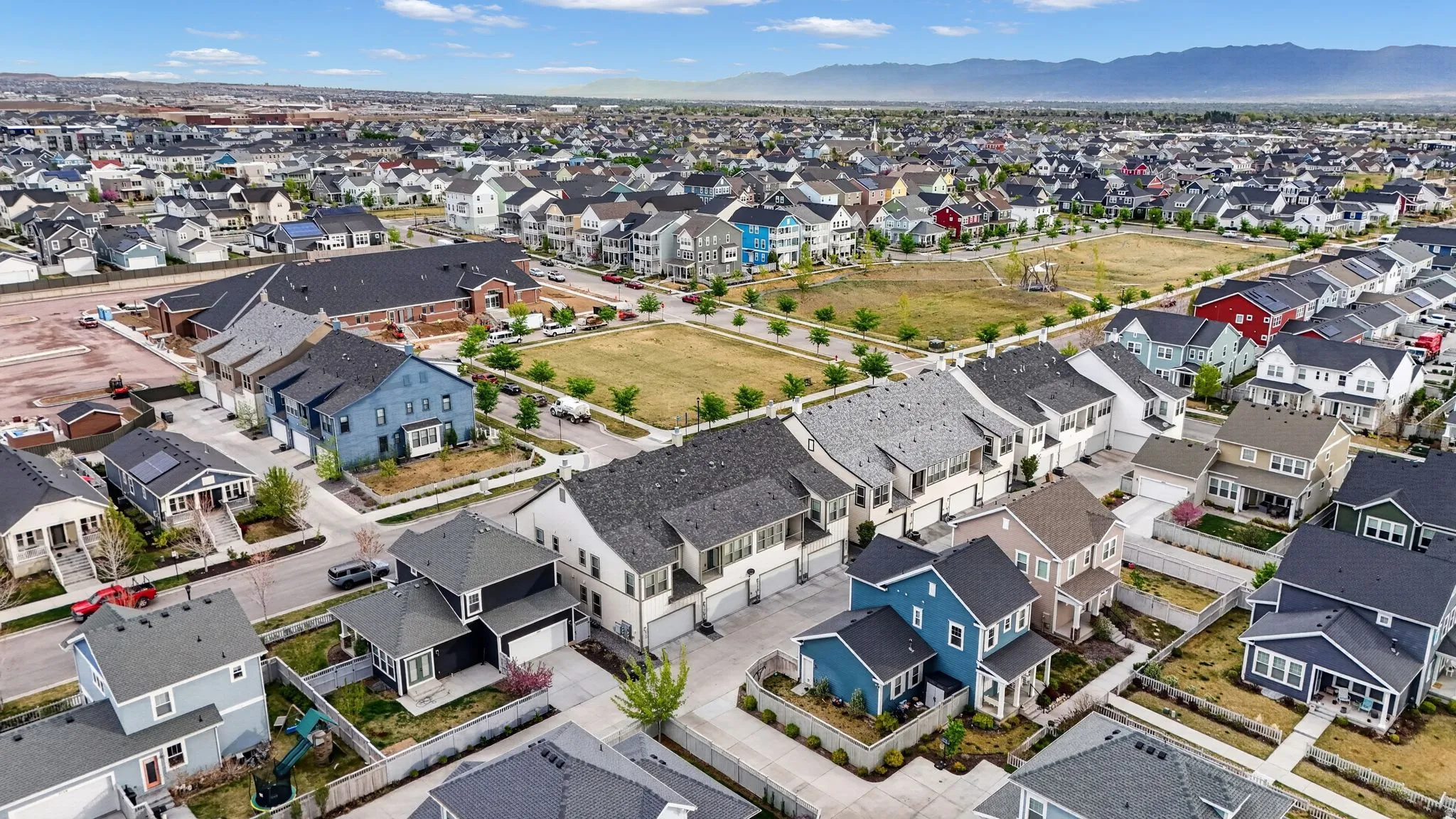 Aerial perspective of suburban area with a mountainous background