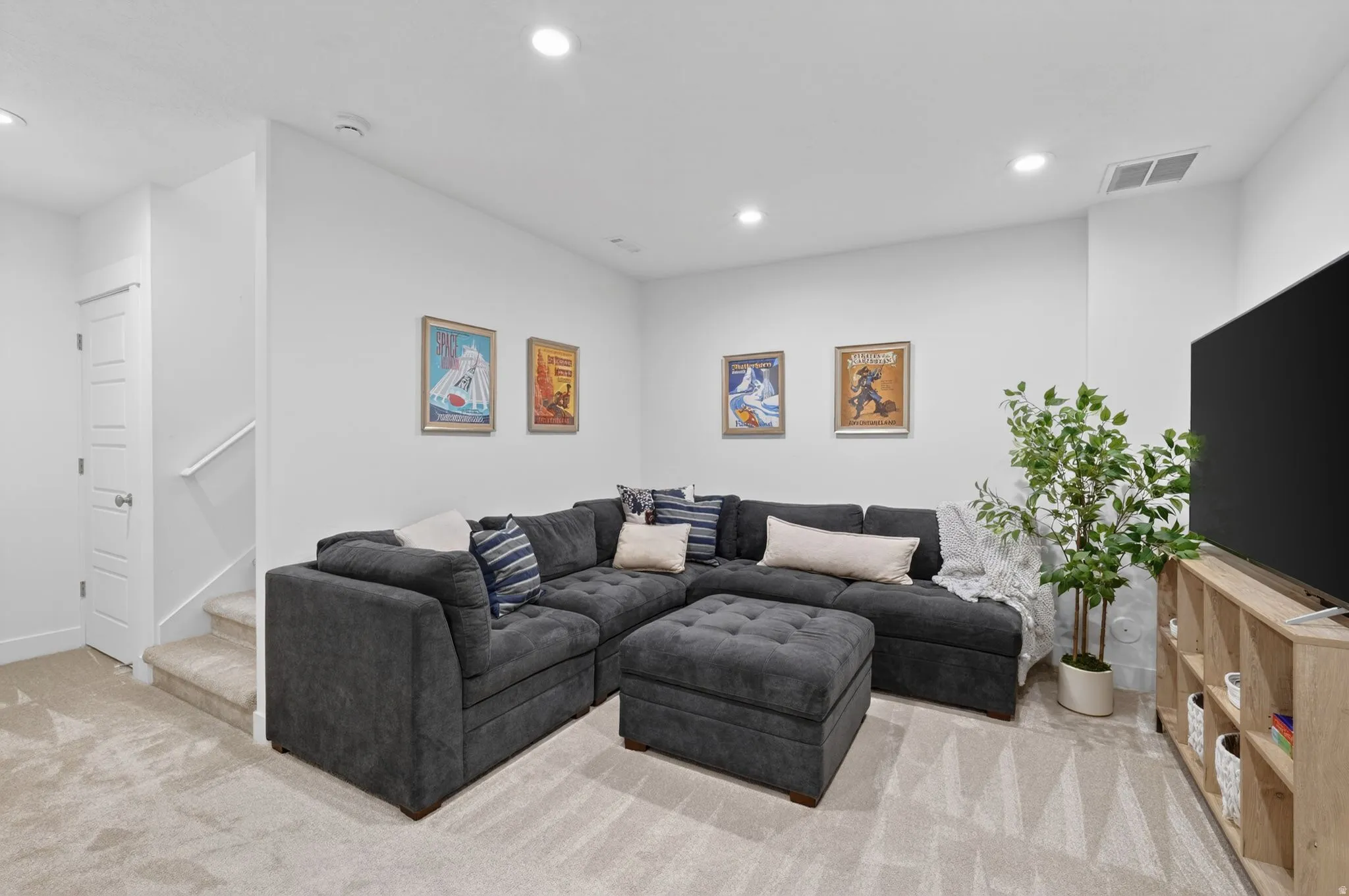 Living area featuring recessed lighting and light carpet