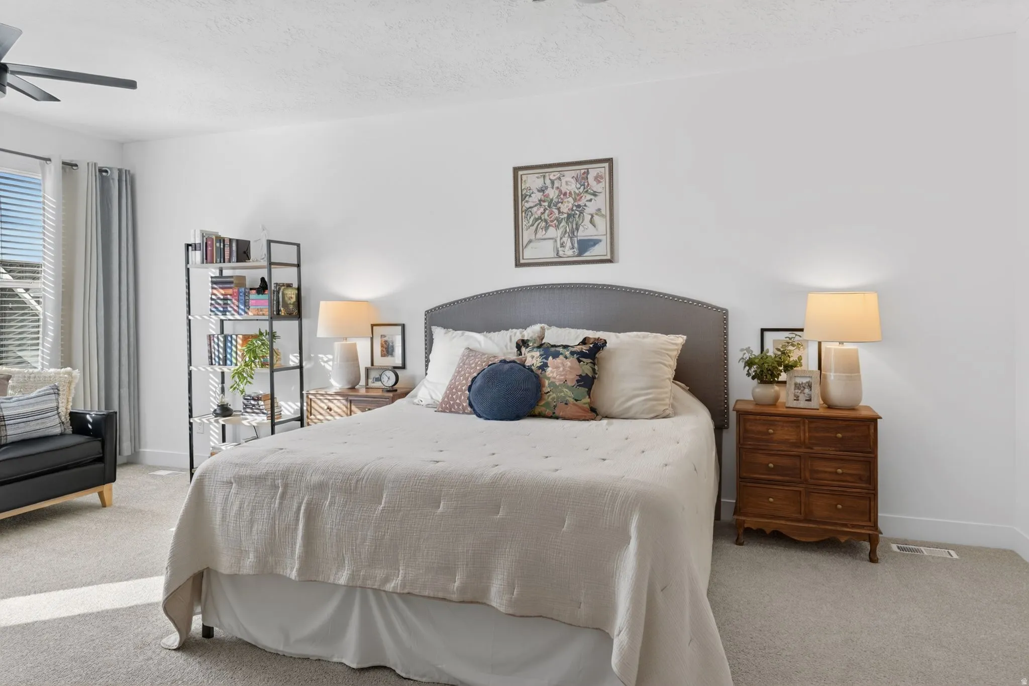 Bedroom with carpet, ceiling fan, and a textured ceiling