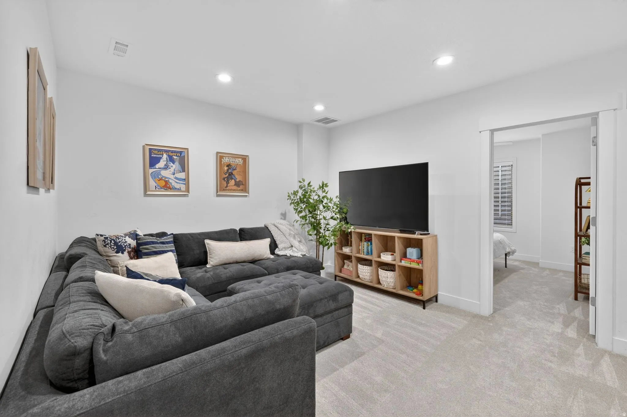 Living room with recessed lighting and light colored carpet