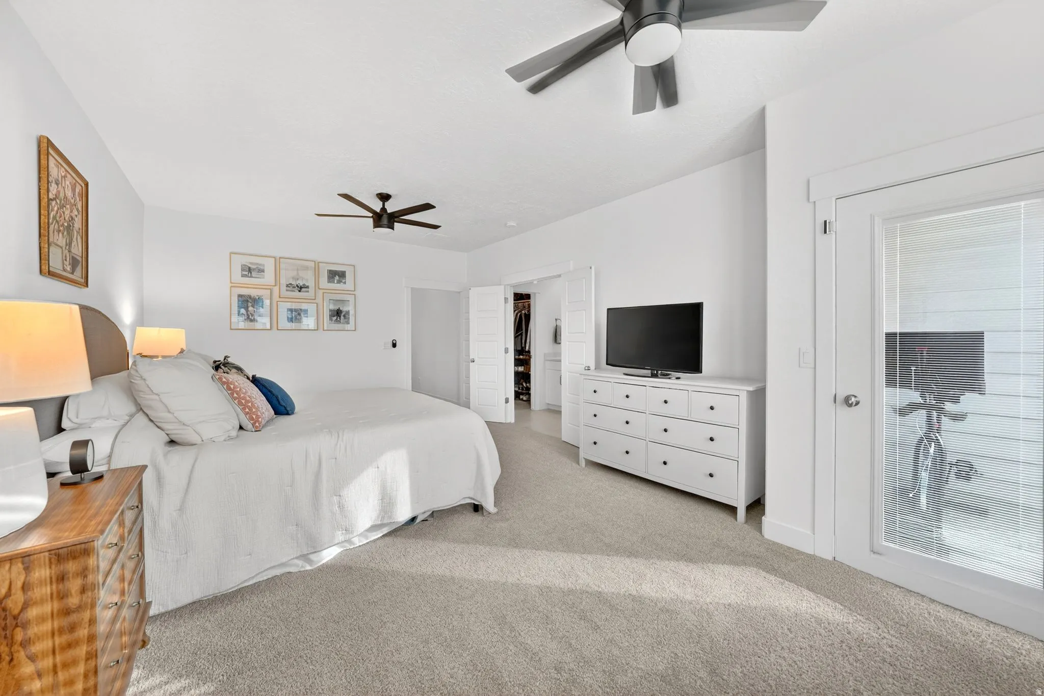 Bedroom featuring access to exterior, ceiling fan, and light carpet