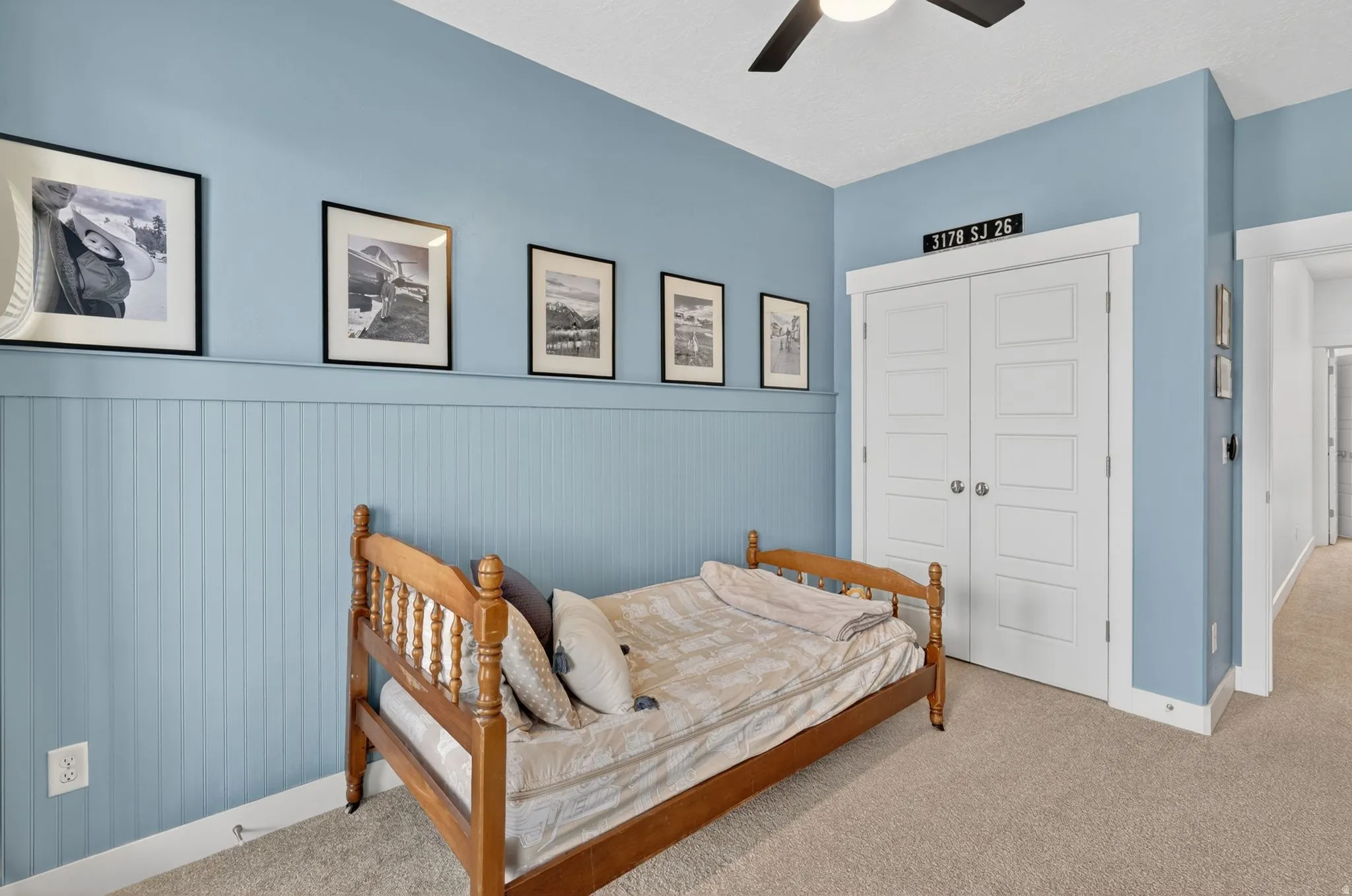 Carpeted bedroom with a closet and a ceiling fan