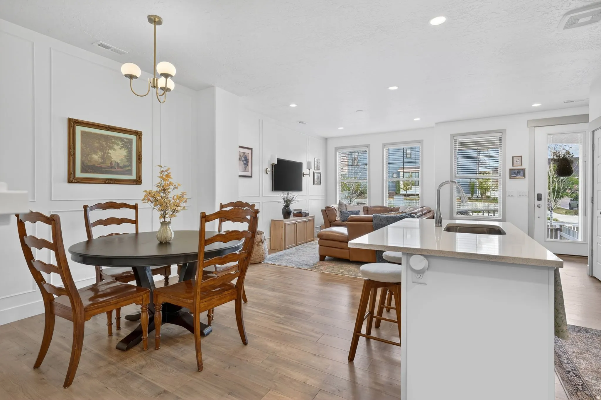 Dining room featuring a decorative wall, light wood finished floors, and a chandelier