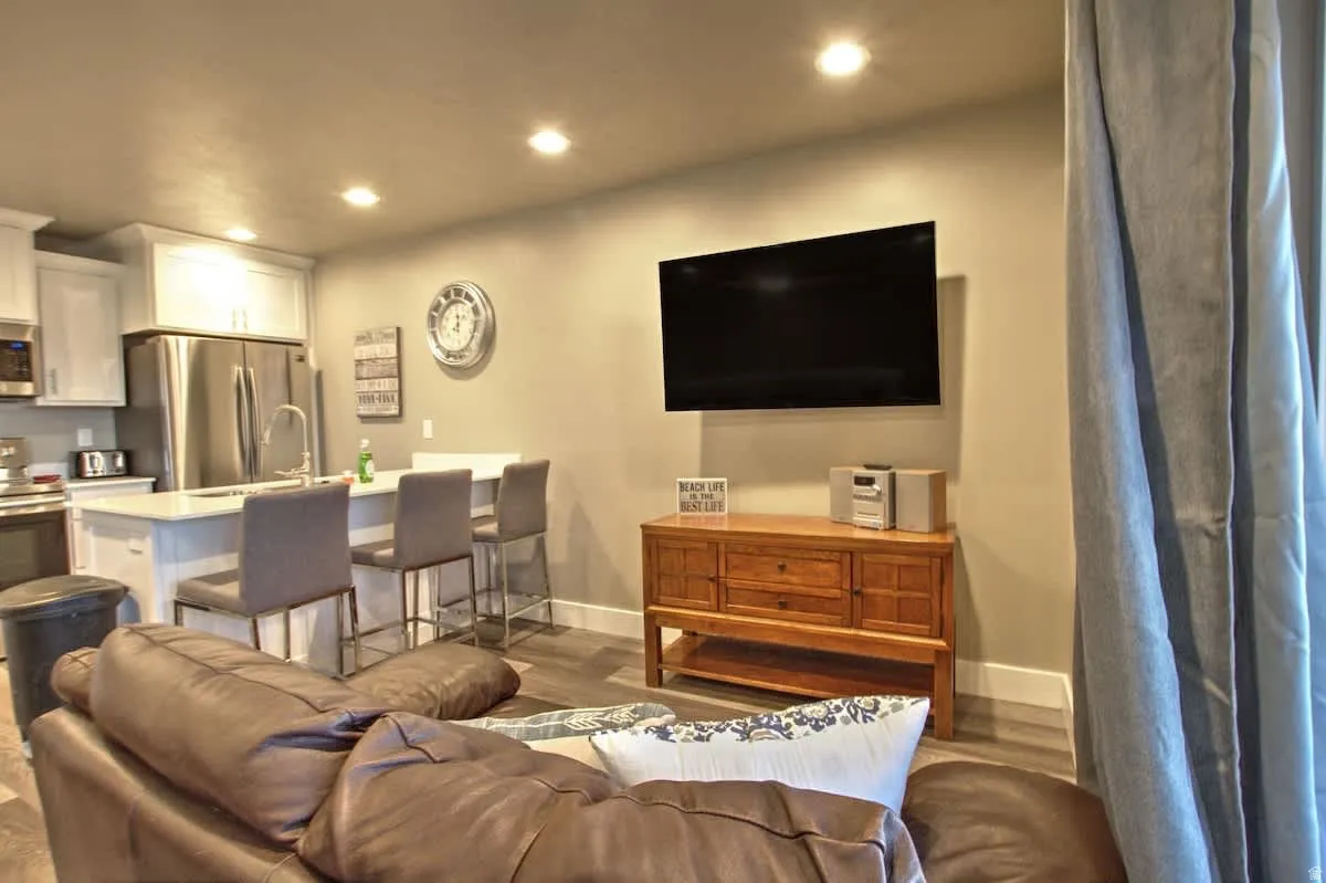 Living room with wood finished floors and recessed lighting