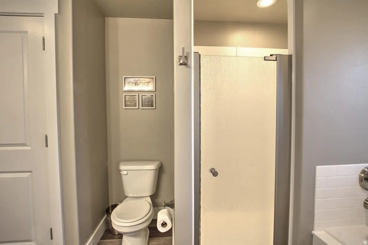 Full bath featuring a stall shower, a bath, and recessed lighting