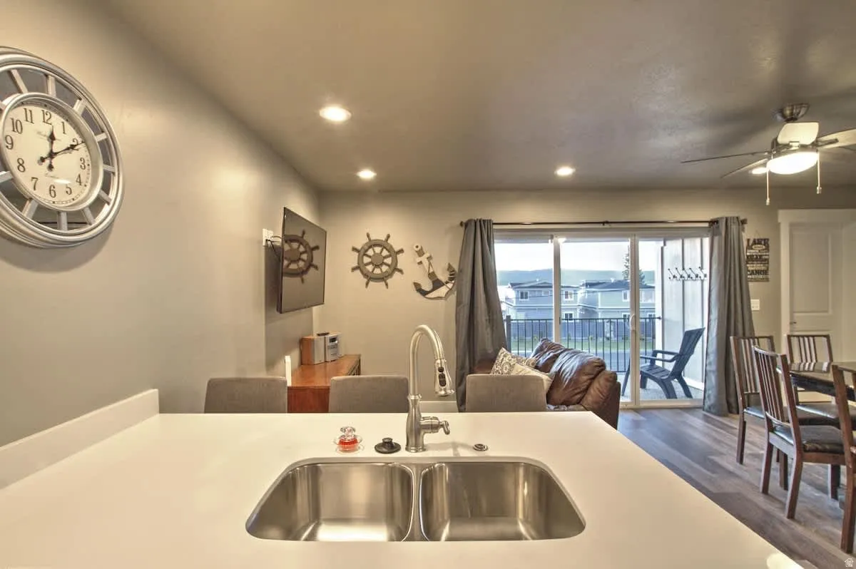 Kitchen featuring a ceiling fan, recessed lighting, dark wood-style flooring, and light countertops