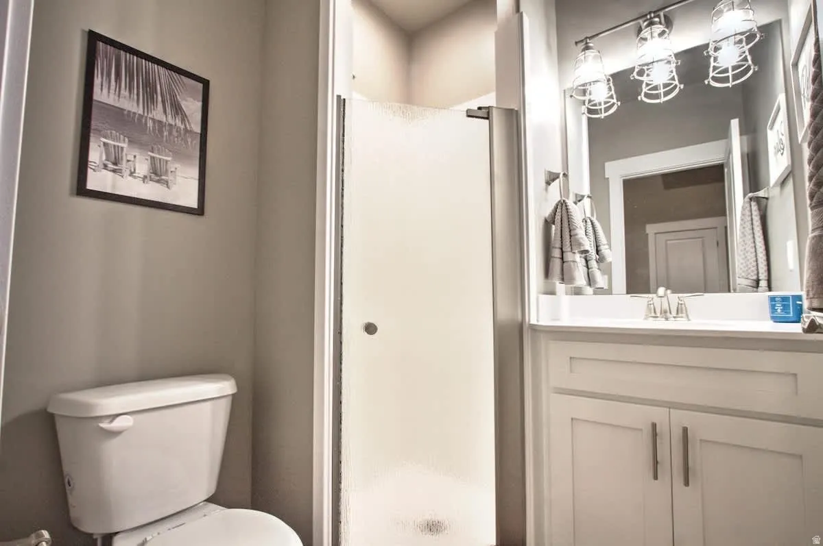 Full bath featuring a shower stall and vanity