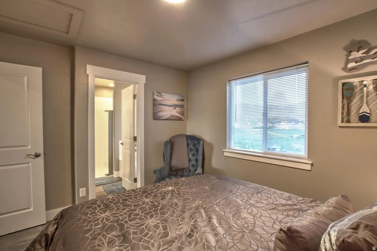 Bedroom with attic access and connected bathroom