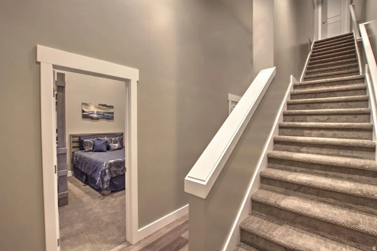 Staircase featuring baseboards and wood finished floors