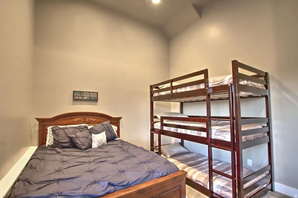 Bedroom featuring a high ceiling and recessed lighting