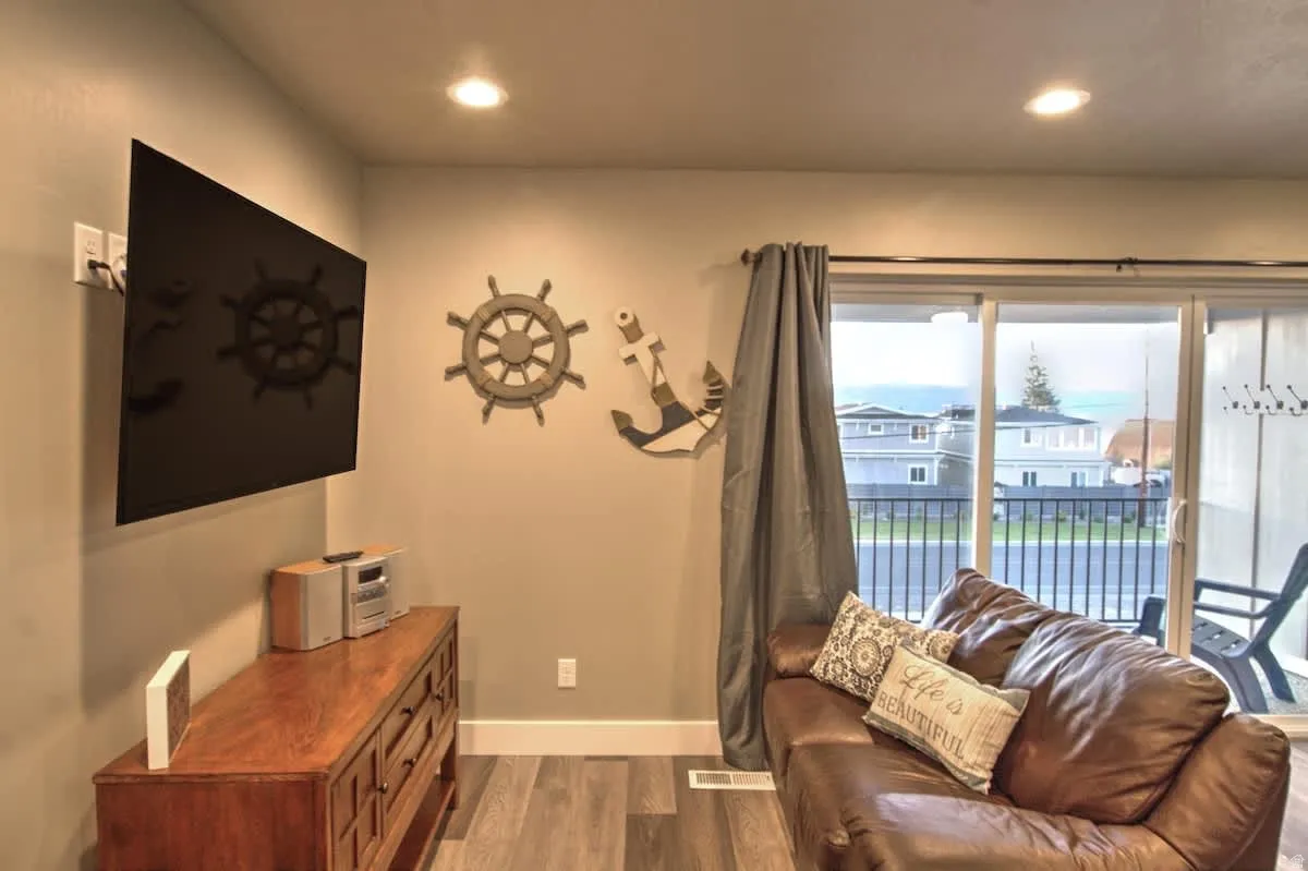 Living room with dark wood finished floors and recessed lighting