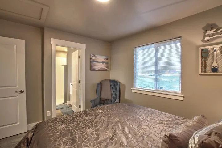 Bedroom with attic access and connected bathroom