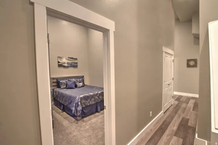 Corridor with a high ceiling and dark wood-style flooring