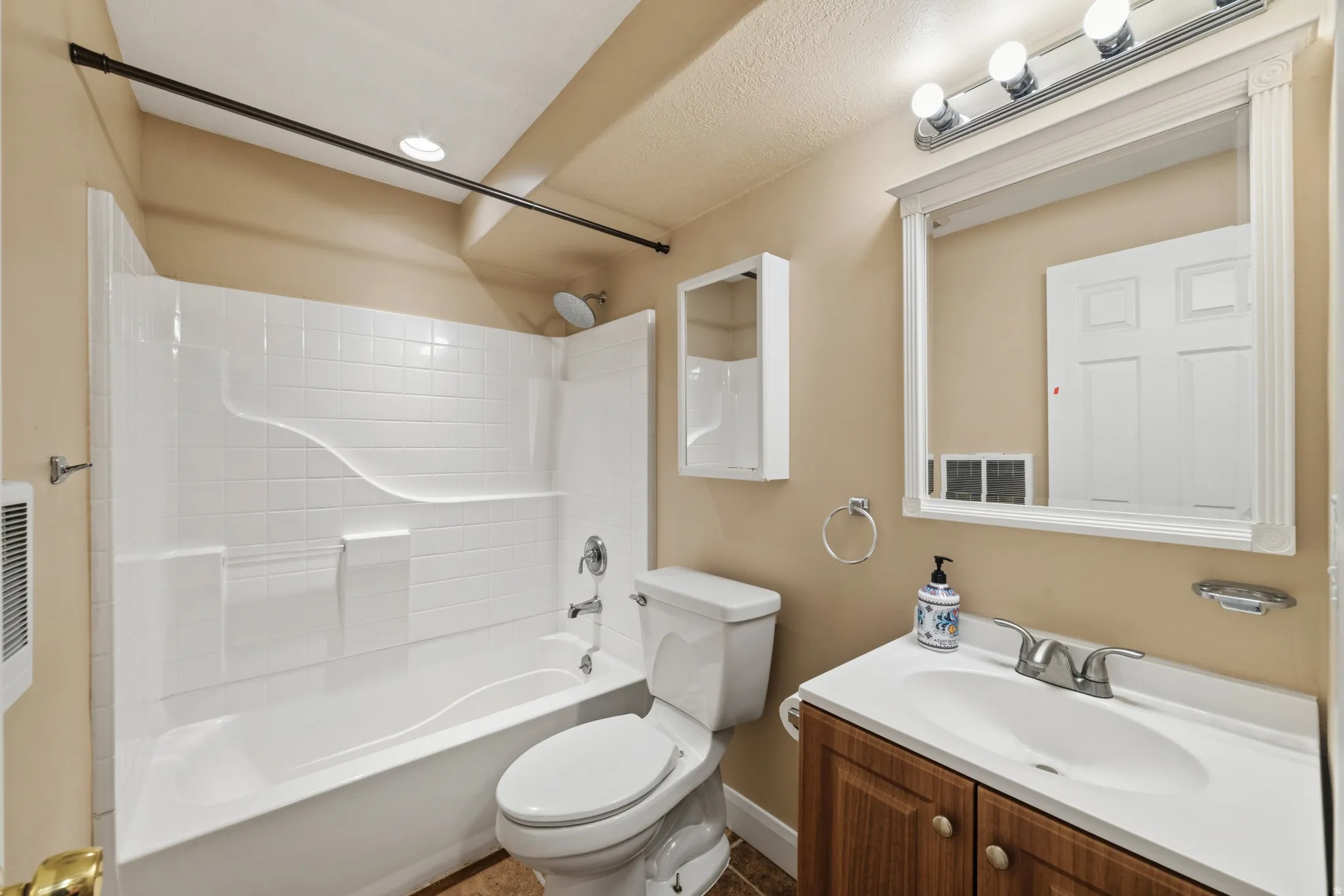 Full bath featuring vanity and  shower combination
