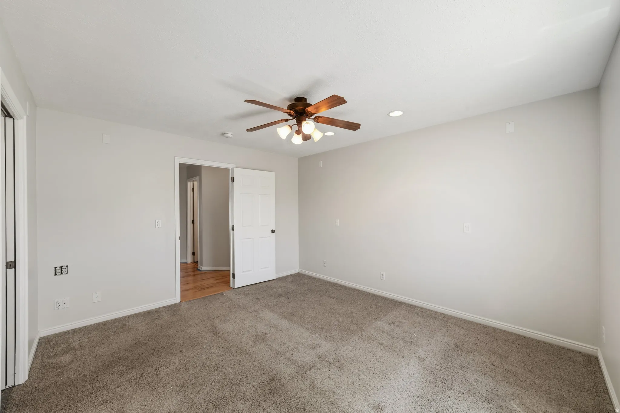 Unfurnished bedroom featuring carpet flooring, recessed lighting, and ceiling fan