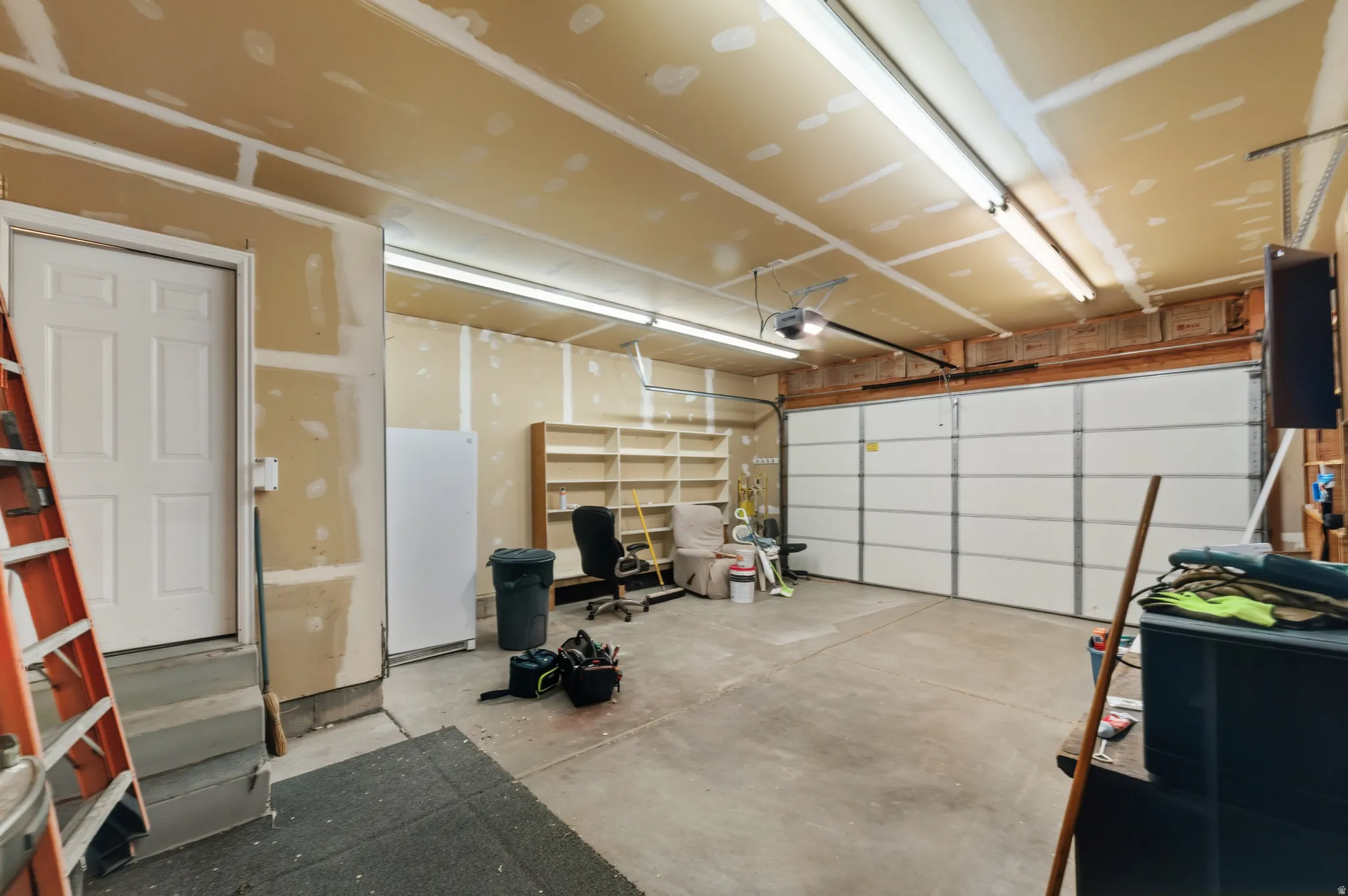 Garage with freestanding refrigerator