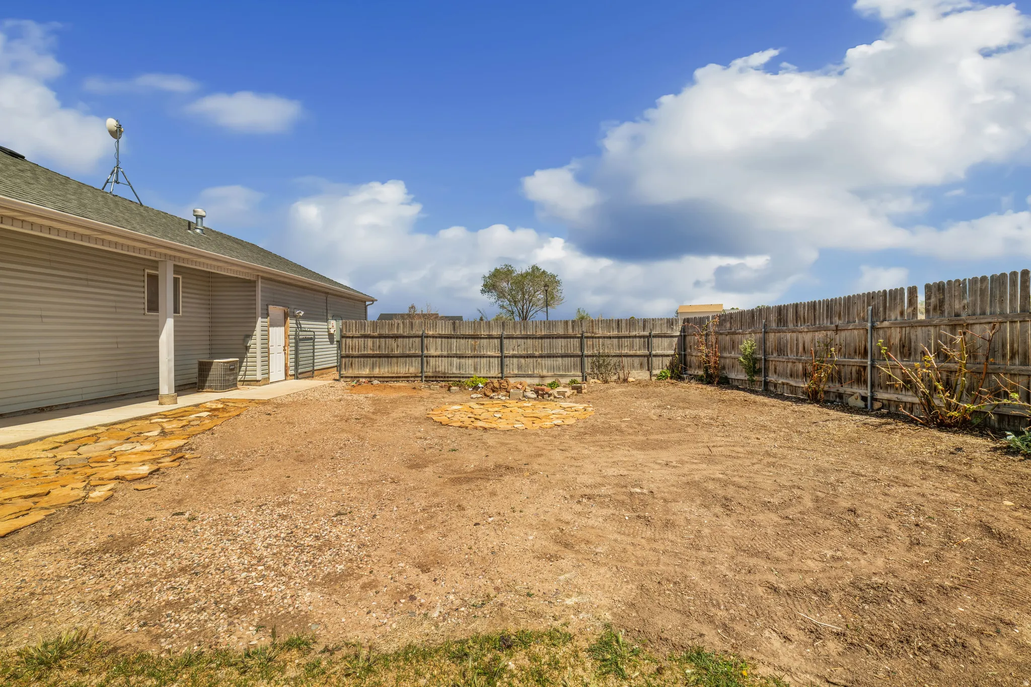 Fenced backyard with a patio area