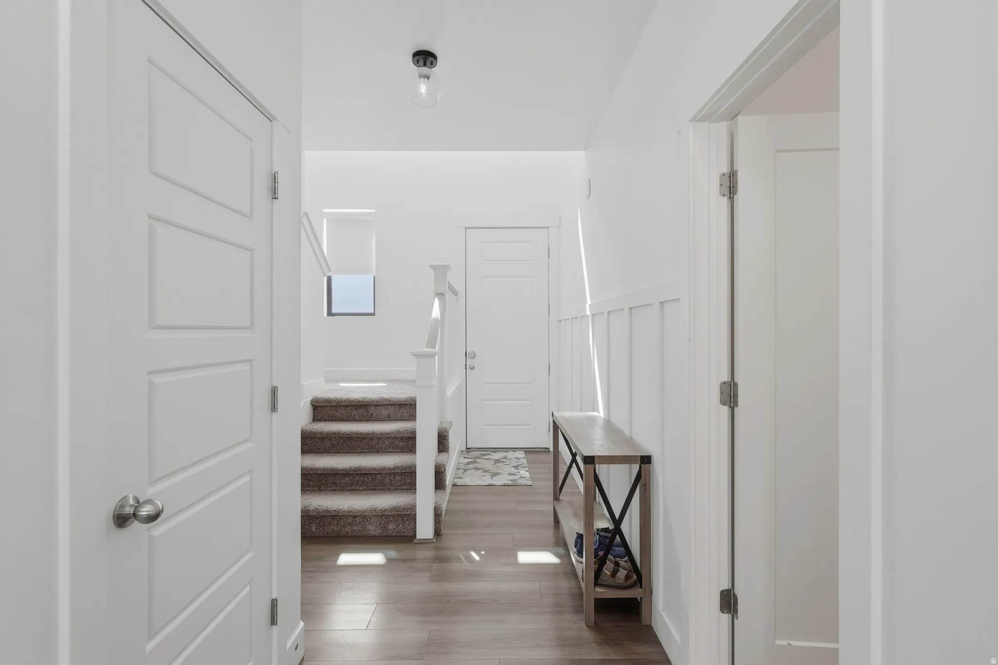 Hall with dark wood finished floors and stairs