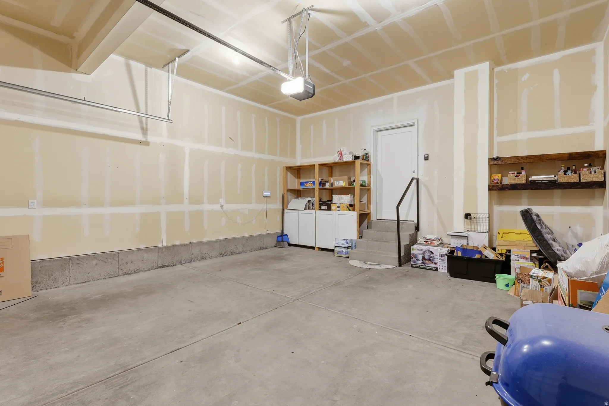 Garage featuring washer and dryer and a garage door opener