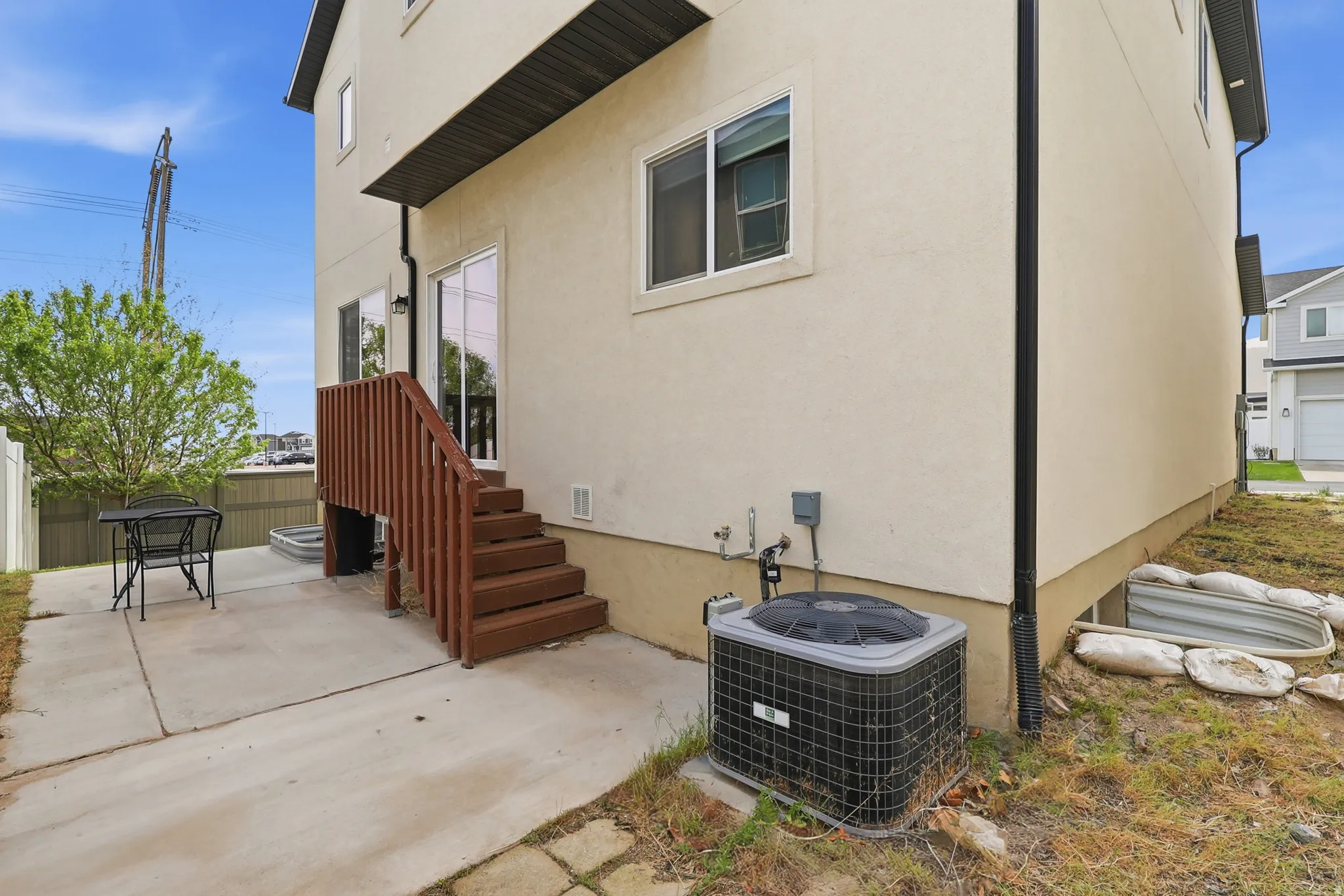 Back of house with sliding glass doors and patio