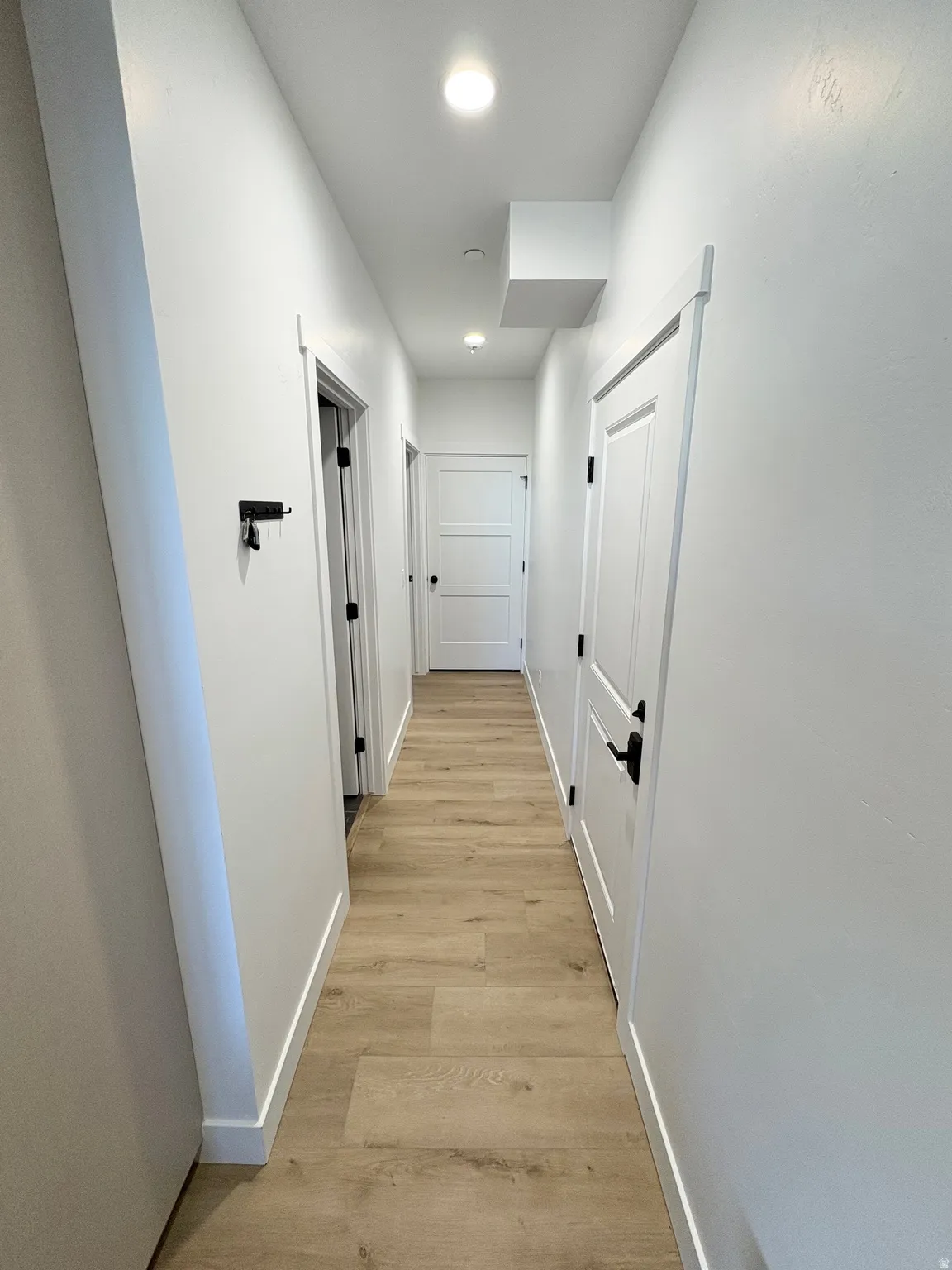 Hall featuring baseboards and light wood-style flooring