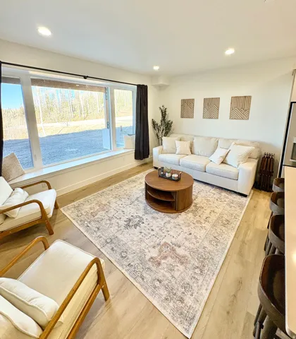 Living room featuring light wood-type flooring and recessed lighting