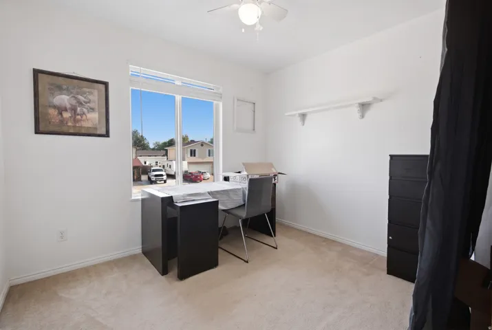Neutral-toned carpet flooring and white painted walls create a bright interior