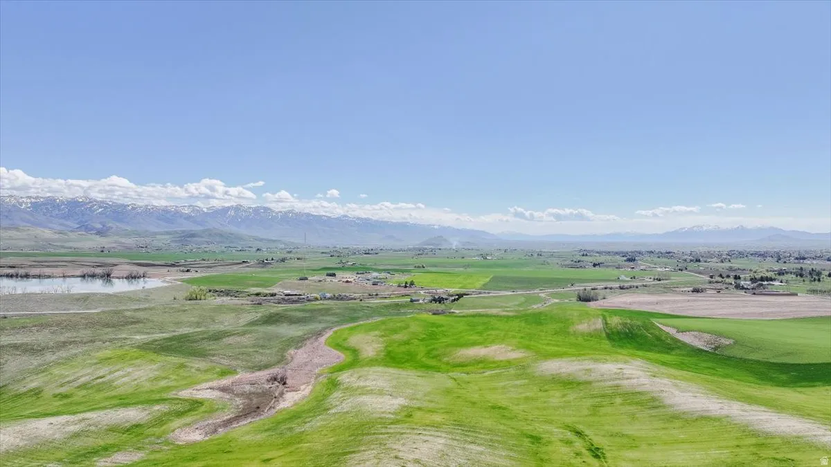 View of home's community featuring view of golf course and a water and mountain view