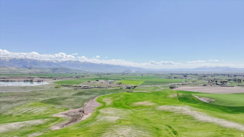 View of home's community featuring view of golf course and a water and mountain view