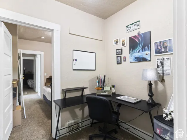 Carpeted interior room with neutral-toned walls