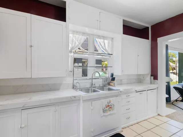 Kitchen featuring white cabinetry and light-toned countertops