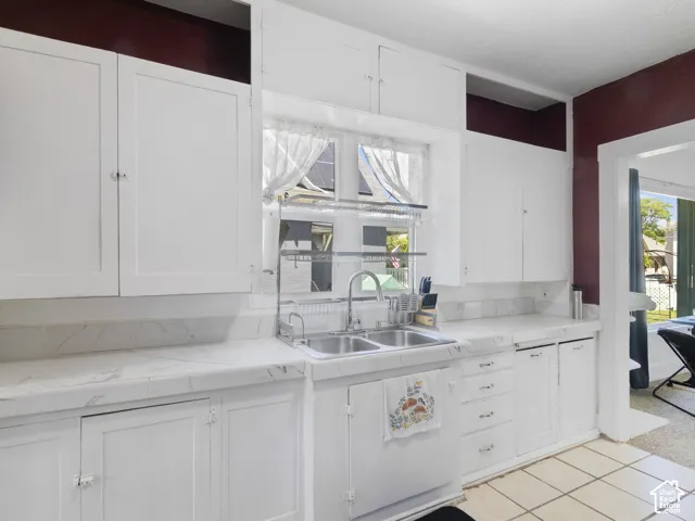 Kitchen featuring white cabinetry and light-toned countertops