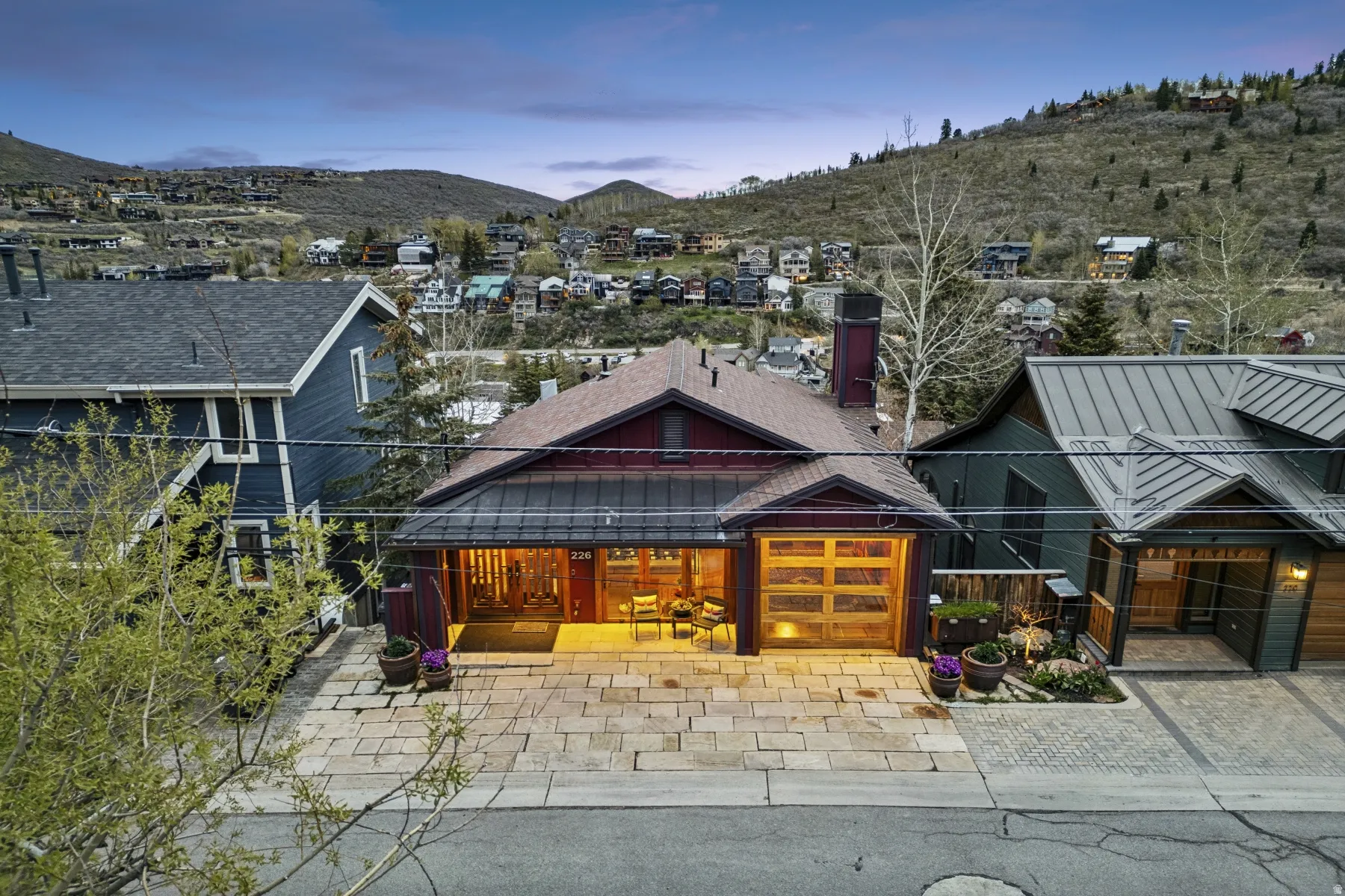 View of front of property featuring driveway, a mountain view, and a residential view