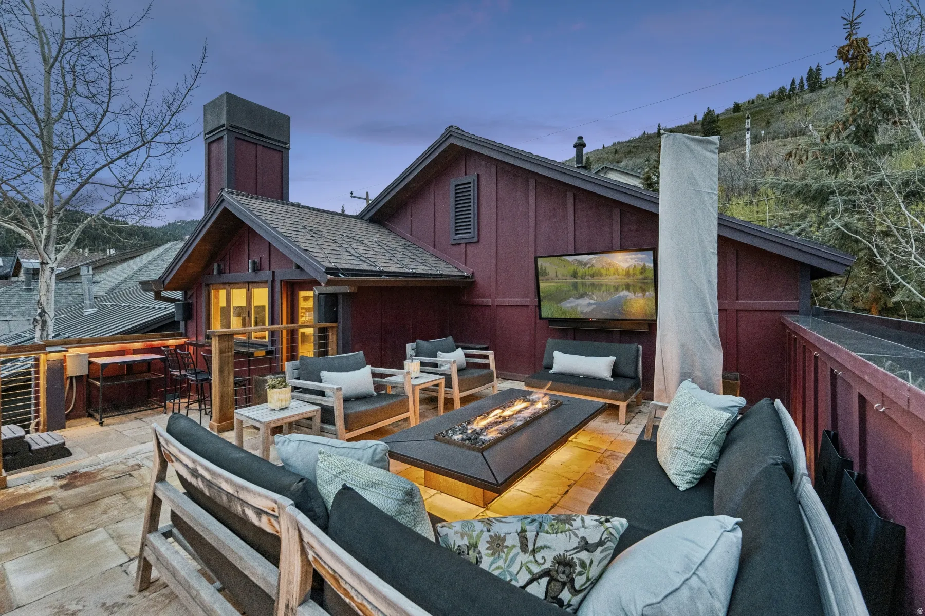 Wooden terrace featuring an outdoor living space with a fire pit and a patio area