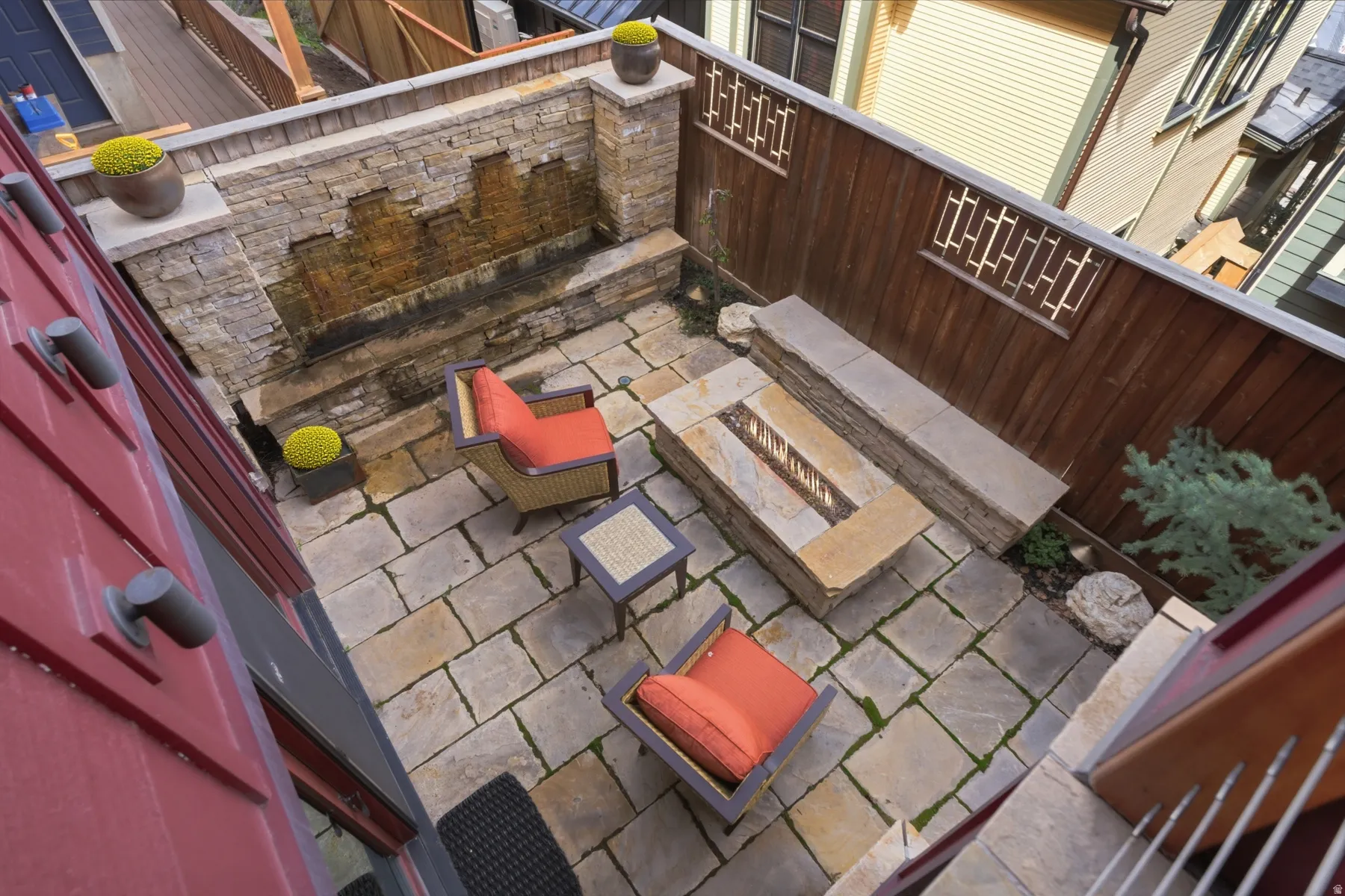 View of patio featuring grilling area and an outdoor stone fireplace