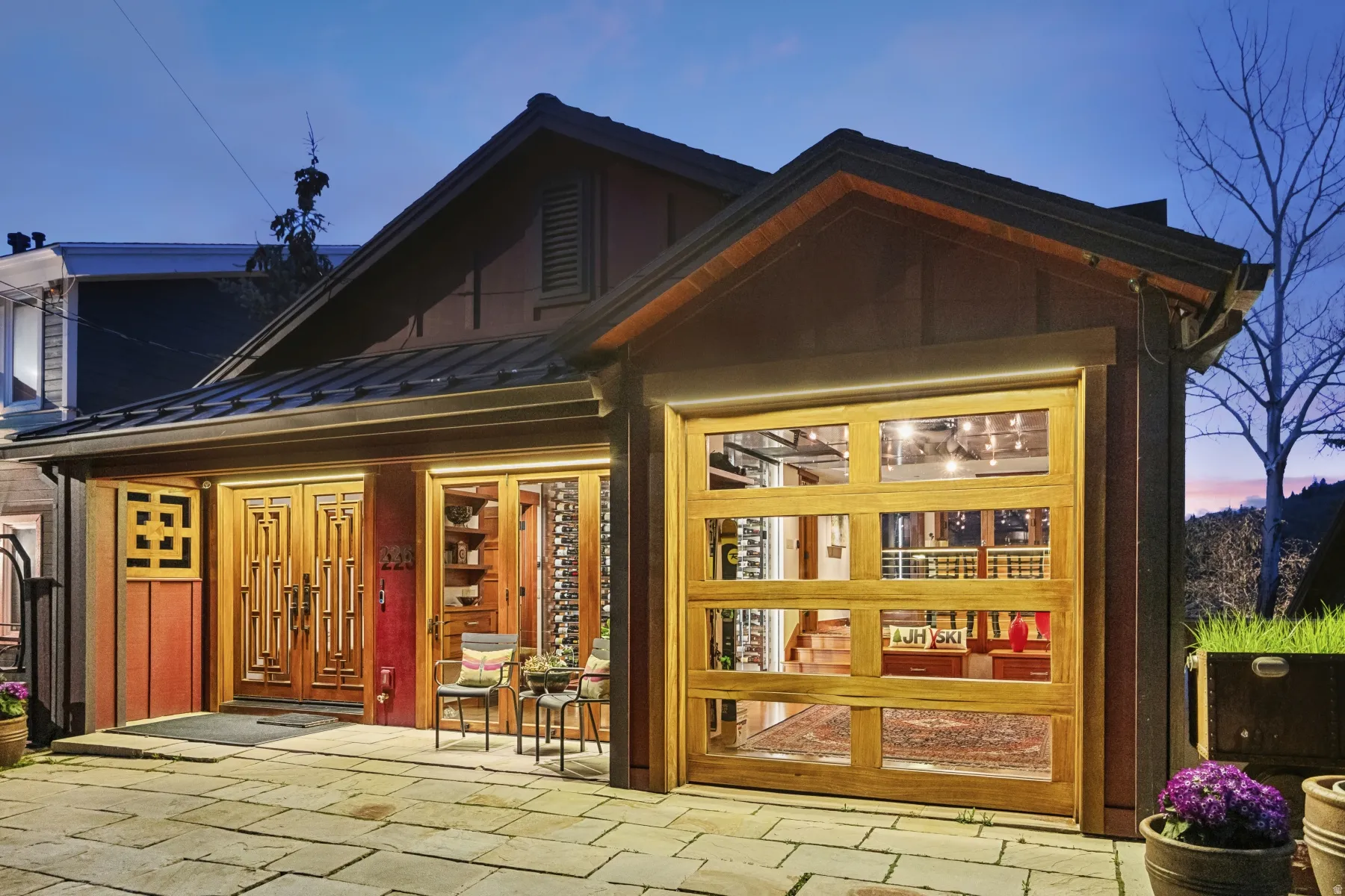 Rear view of property featuring a standing seam roof and a patio area
