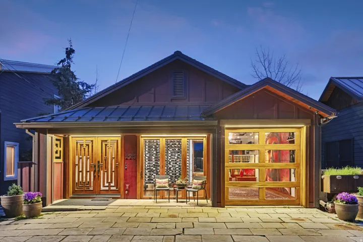Property entrance with board and batten siding, a standing seam roof, and covered porch