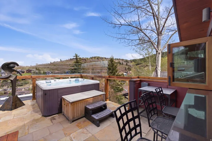 View of patio with a hot tub