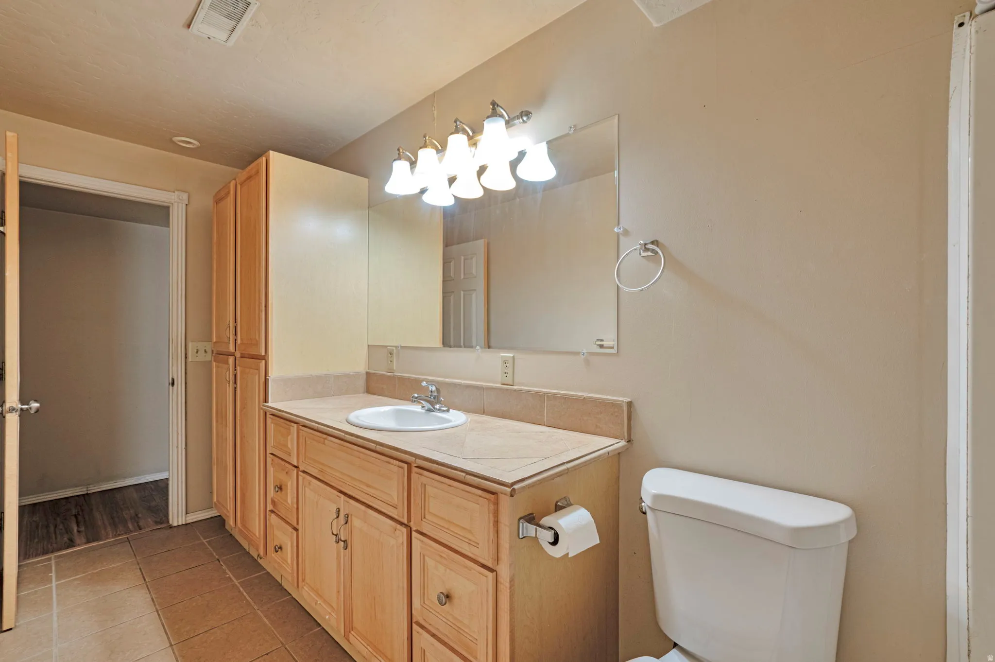 Bathroom featuring vanity and light tile patterned flooring