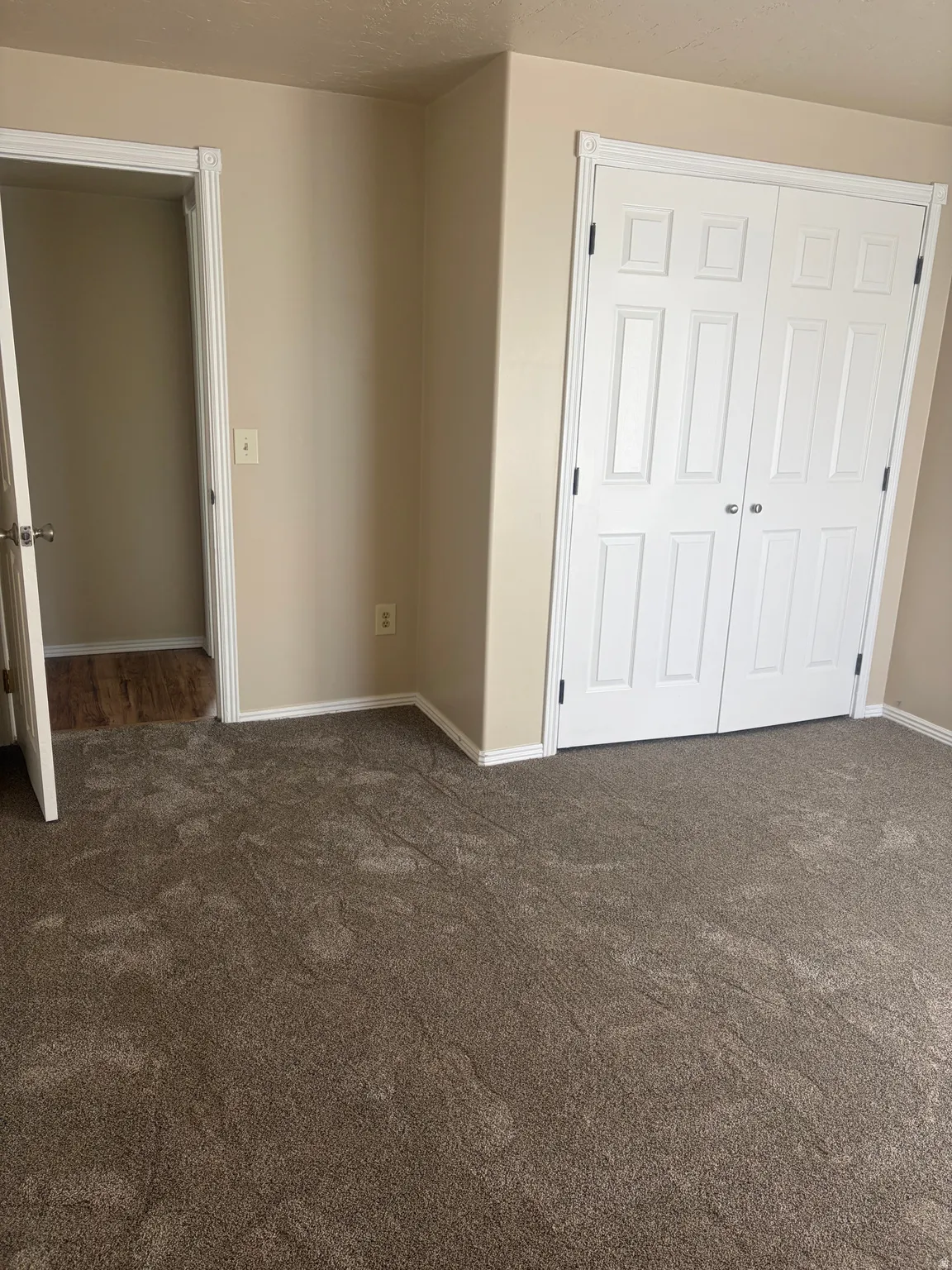 Unfurnished bedroom with dark colored carpet and a closet