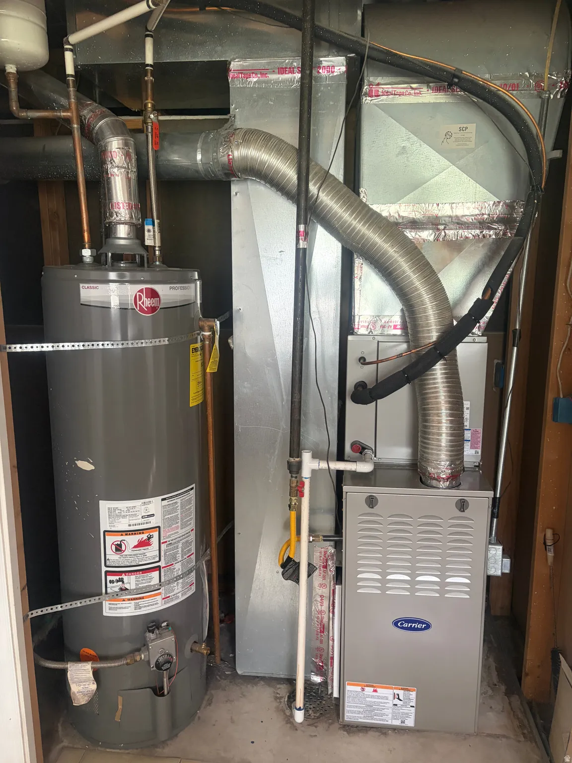 Utility room featuring water heater and heating unit