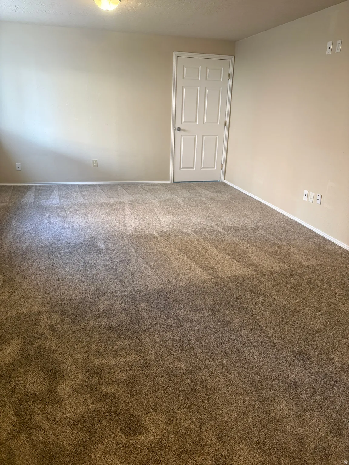 Carpeted spare room with baseboards