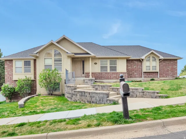 Ranch-style house featuring brick siding and roof with shingles
